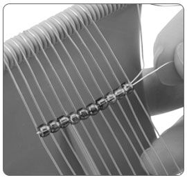 Beads threaded onto loom